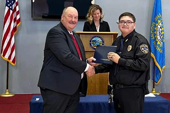 Richard Two Two Sr., right, receives congratulations from DCI Director Dan Satterlee upon completion of SD Basic Law Enforcement Certification.