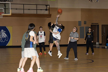 A St. Joseph’s Indian School staff member and student face off at the jump ball, setting the tone for what would become a close game.