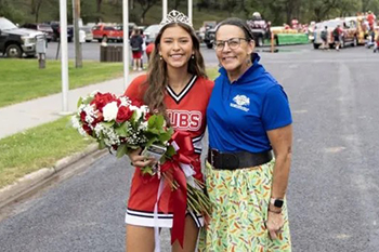 Queen Makaia and Native American Studies teacher LaRayne smile for a photo during Chamberlain’s Homecoming parade.