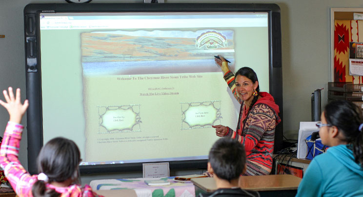 Male students participate in drum group, which helps them learn the Lakota language. 