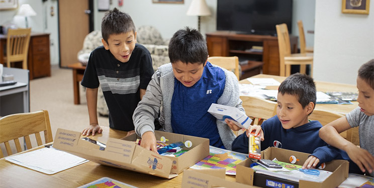 Native american youth reading books donated by generous people like you.